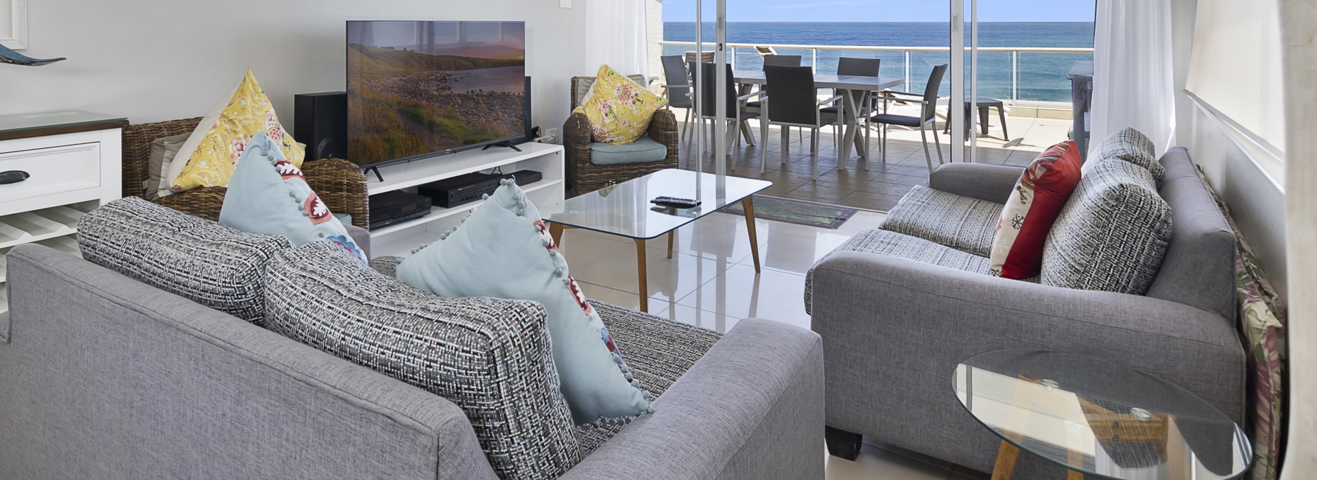 Ballito Beach Manor 304 — living area onto the sea-facing balcony