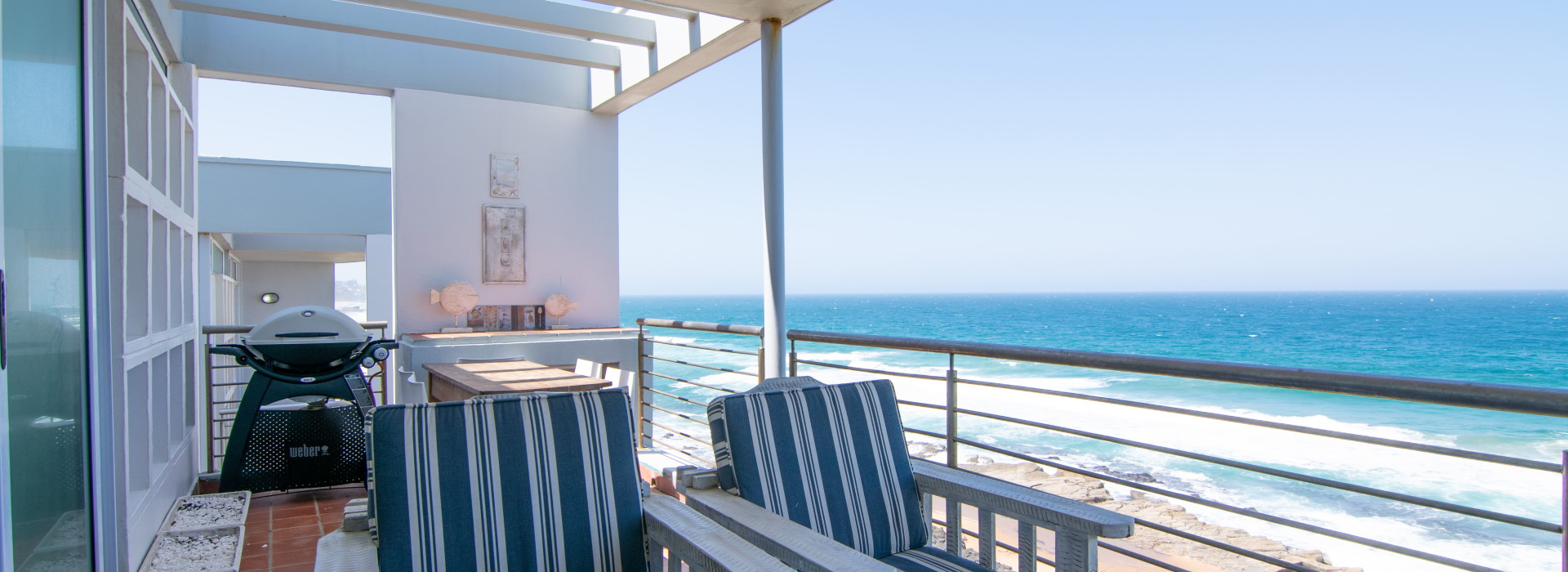 Holiday home terrace with sun loungers facing the Indian Ocean