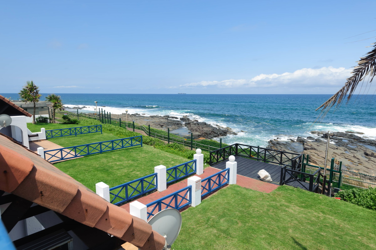Terraced lawns running down to the tidal rocks at Salt Rock
