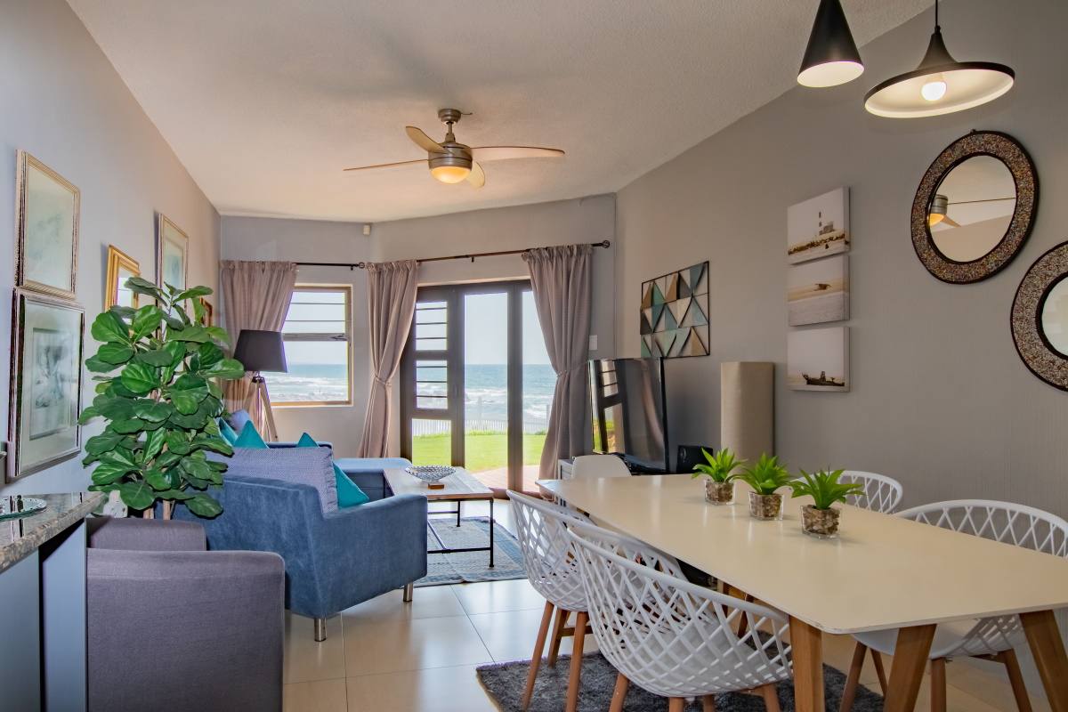 Wide covered veranda looking over indigenous coastal bush to the sea